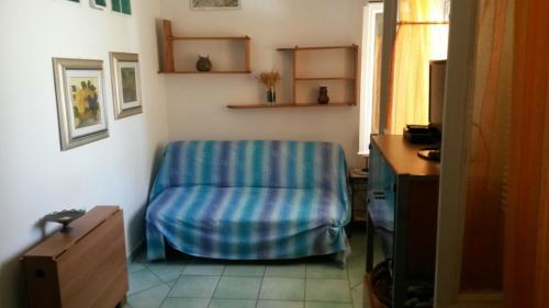 a room with a blue chair in a room at A casa di Tommasino in Ponza