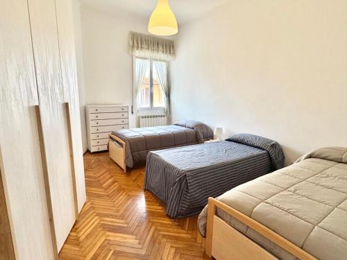 a bedroom with two beds and a window at Casa Margherita in Ospedaletti