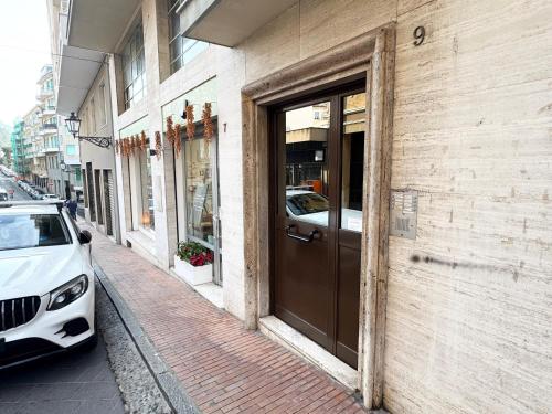 a white car parked on a sidewalk next to a building at Casa Margherita in Ospedaletti
