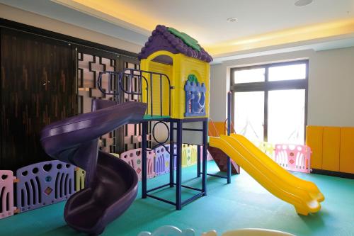 a childrens play room with a slide and a playground at Golden Tulip - Aesthetics in Zhunan