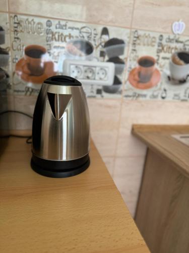 a tea kettle sitting on a counter in a kitchen at Edy Central Apartment in Arad