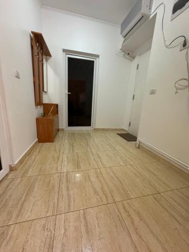 an empty room with a wooden floor and a door at Edy Central Apartment in Arad