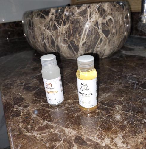 two bottles of honey sitting on a counter at Chez Mamouchthka in Ourika
