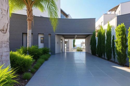 a building with a palm tree and a walkway at Beachfront Luxury Villa Glory in Ayia Napa