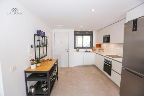 a kitchen with white cabinets and a counter in it at Icon Luxury Seaview Marina in Almuñécar
