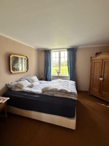 a bedroom with a large bed with a window at Alte Meierei in Westensee