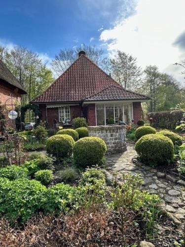 a house with a garden in front of it at Alte Meierei in Westensee