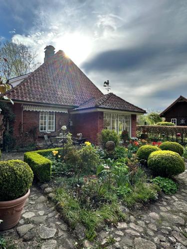 a house with a garden in front of it at Alte Meierei in Westensee