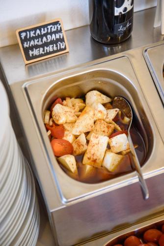 a pan of food with chicken and vegetables on a counter at Maravar - Pivný Wellness Adults Only in Liptovský Trnovec