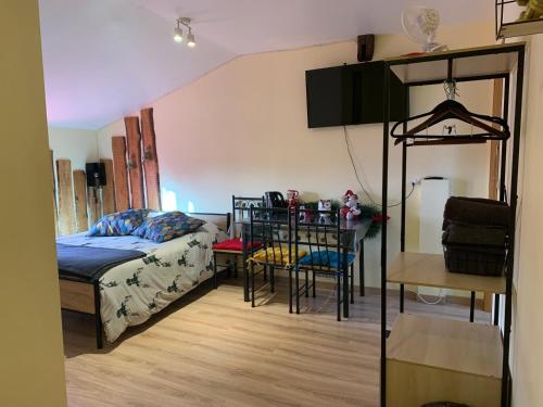 a bedroom with a bed and a table with chairs at Chez Franck et Sandra, plein centre ville , 2eme étage in Sainte-Menehould