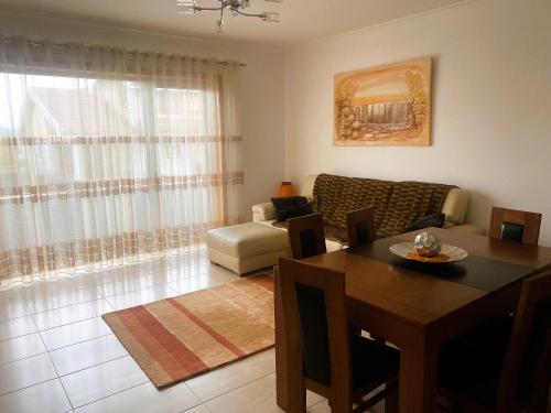 a living room with a table and a couch at T3 Aguiar in Vila Pouca de Aguiar