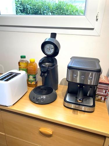 a coffee maker sitting on top of a counter at Maison Eysines- A10 in Eysines