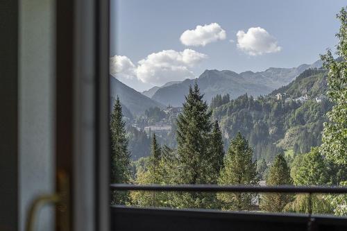 a view of a mountain range from a window at EUROPÄISCHER HOF Bad Gastein in Bad Gastein