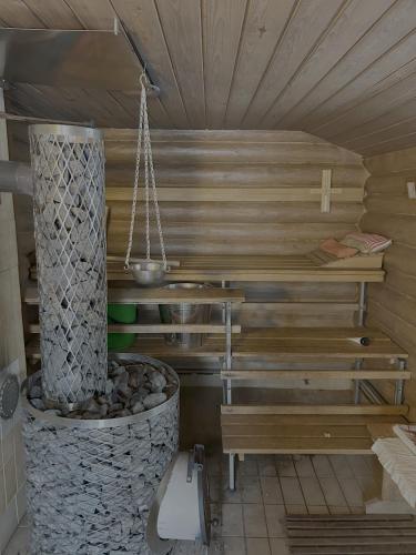 a room with a sauna with a bench and a fire place at Relaxy in Pieksamaki