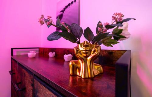 a gold statue of a woman holding flowers on a table at Balneotherapy, cozy, family-friendly in Villars