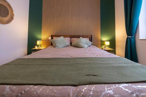 a bedroom with a large bed with two lamps at Balneotherapy, cozy, family-friendly in Villars