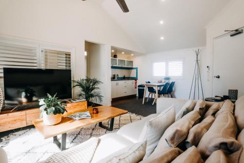 a living room with a couch and a table at Maui - Bay Lane Retreat - 1 minute to beach in Byron Bay