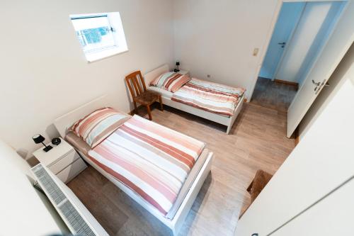 a small room with two beds and a window at MonteurGut Apartments Kastanie in Marren
