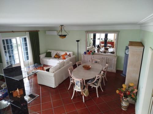 a living room with a table and a couch at Casa Rua dos Loureiros in Marco de Canaveses