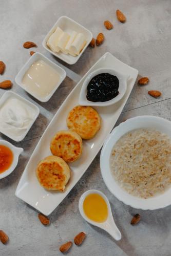 a table with a plate of food and bowls of food at Апарт-отель Tong Marina in Tong