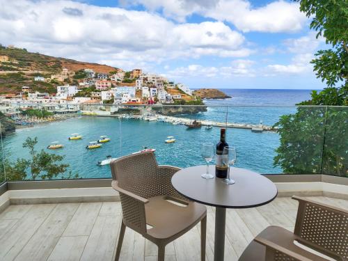 a table with two wine glasses and a view of a harbor at Blue Bay Lifestyle - ex Bali Blue Bay in Balíon