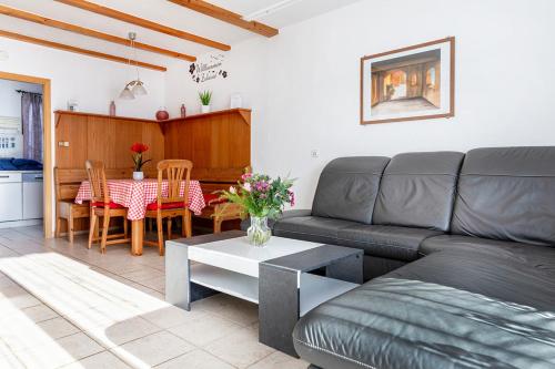 un salon avec un canapé et une table dans l'établissement Ferienhaus Nr 105, Kategorie Komfort, Feriendorf Hochbergle, Allgäu, à Karlsebene