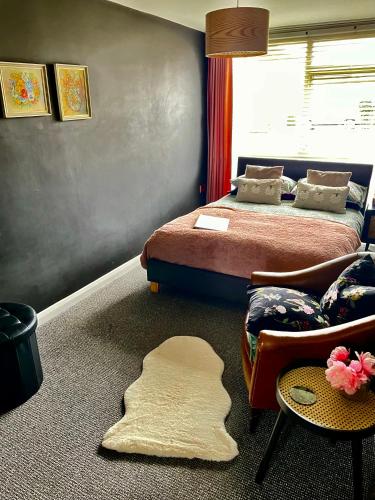 a bedroom with two beds and a rug on the floor at The Big Slepe in St. Ives