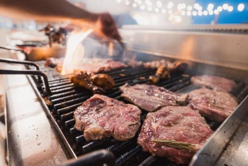 a bunch of meat cooking on a grill at Waterfront in Sliema