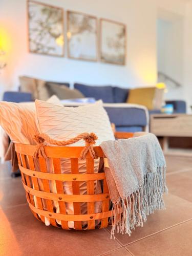 a basket with a blanket on top of it at Epidavros View Villas in Ancient Epidavros