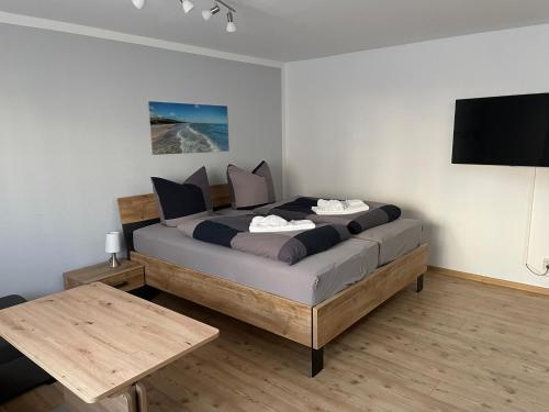 a bedroom with a bed with a tv on the wall at Ferienhaus Pank in Heringsdorf