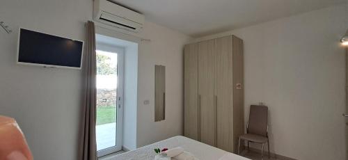 a bedroom with a bed and a television on the wall at Al Mare da Francesca in Olbia