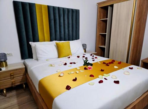 a bedroom with a bed with roses on it at COLT DE RAI-Deluxe & Spa in Reşiţa