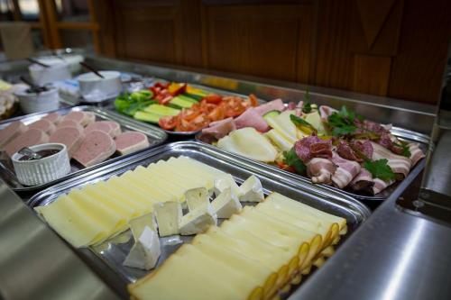 a buffet with different types of cheese and meats at Hotel Gold Chotoviny in Chotoviny