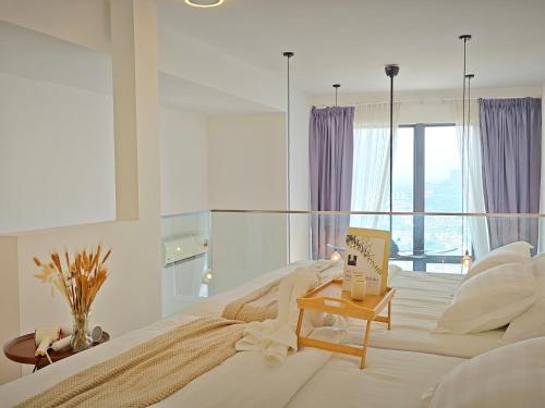 a white bedroom with a large bed with a window at Urban Loft MRT Convenience KLCC Nearby in EKO CHERAS in Kuala Lumpur