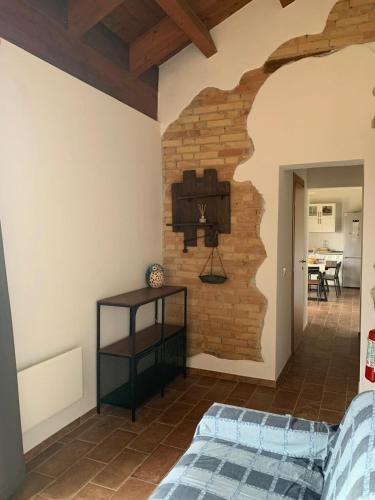 a bedroom with a brick wall and a bed at La stalla di nonno Zopito casa vacanze in Loreto Aprutino