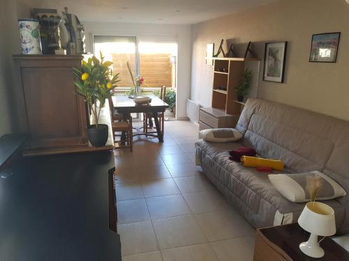 a living room with a couch and a table at Entire apartment 62 m2 3 rooms 1st floor in Bezons