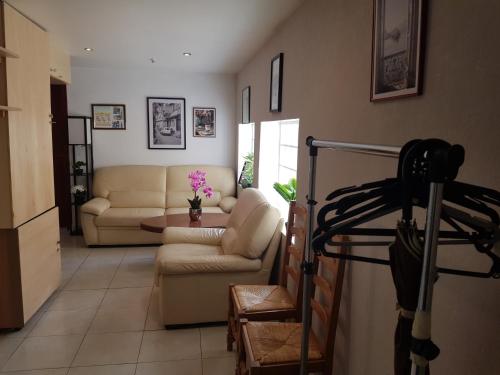 a living room with a couch and a table at Entire apartment 62 m2 3 rooms 1st floor in Bezons