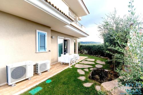a backyard with a heater and a lawn at Marina House - Luxury apartment, sea view, WI-FI, Aircon - Key to Villas in Castelsardo