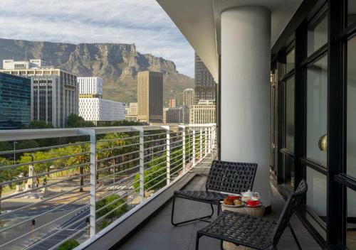 a balcony with chairs and a view of the city at The Onyx Apartment Hotel by NEWMARK in Cape Town