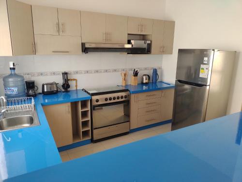 a kitchen with blue counters and a stainless steel refrigerator at DepartoCasa1 Premium in Arica