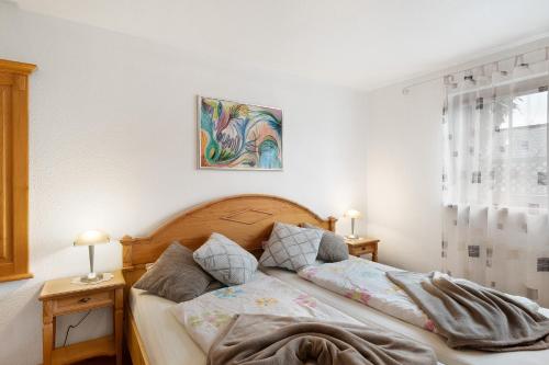 a bedroom with a bed with two night stands and two lamps at Ferienwohnung Heike Schreiber in Sasbachwalden