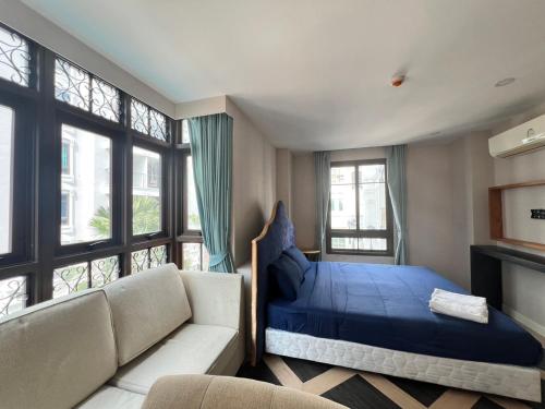 En eller flere senge i et værelse på Espana Jomtien Pattaya By Thita