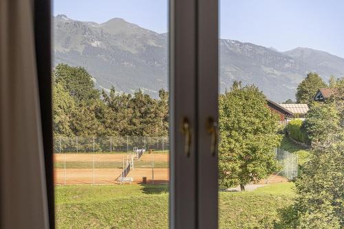 a view of a tennis court from a window at EUROPÄISCHER HOF Bad Gastein in Bad Gastein