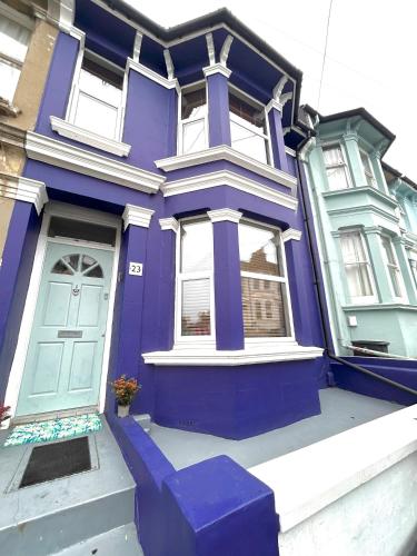 a purple house with a blue door on a street at Hanover House in Brighton & Hove