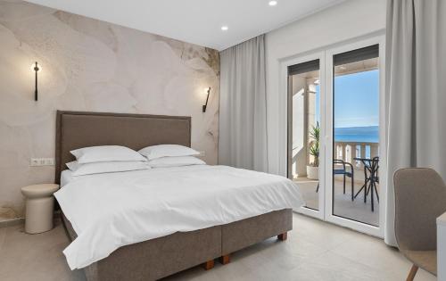 a bedroom with a bed and a view of the ocean at Luxury Tommy's Apartment in Duće