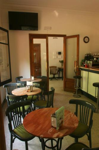 a restaurant with tables and chairs and a kitchen at Hostal Montsoliu in Arbúcies