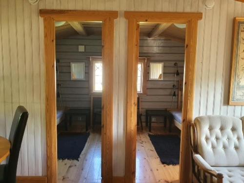 a room with two doors and a table and chairs at Mora Life, Åmåsängsgården in Mora