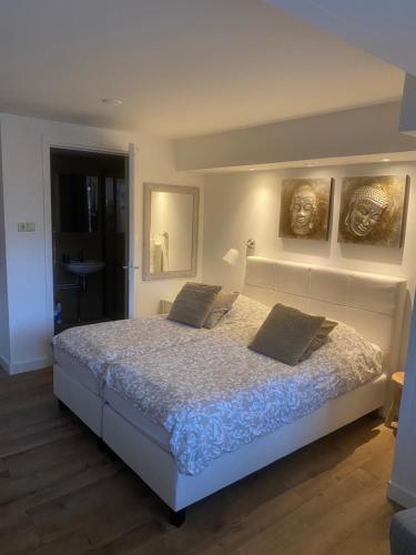 a bedroom with a bed with two pillows on it at Pension Hendriks in Zandvoort