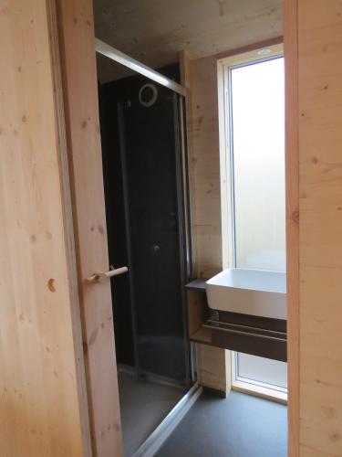 a bathroom with a sink and a window at Cala Fearnadh Off-Grid cabin, Bunessan, Mull in Bunessan