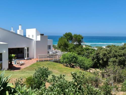 a view of the ocean from a house at Southern Cross Beach House in Groot Brak Rivier